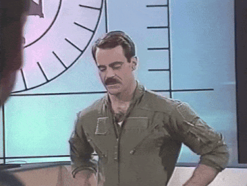 a man in a military uniform with a mustache stands in front of a clock