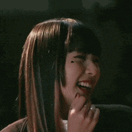 a woman with a ring on her finger is smiling and laughing .