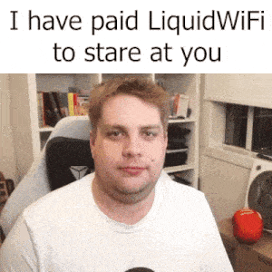 a man sitting in a chair with the words i have paid liquid wifi to stare at you above him