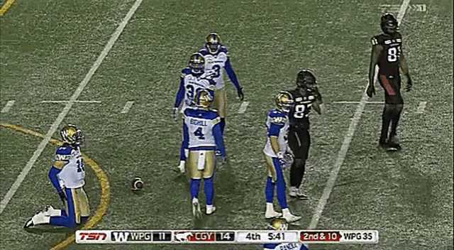 a football player with the number 4 on his jersey is kneeling down