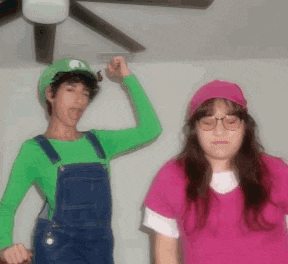 a man dressed as luigi and a woman dressed as a nurse pose for a picture