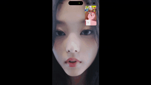 a phone with a picture of a woman on the screen surrounded by cartoon characters