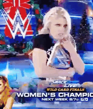a woman is holding a trophy in front of a sign that says women 's champic