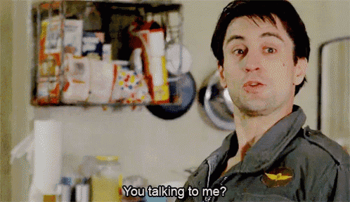 a man in a military uniform is talking to another man in a kitchen and says you talking to me ?