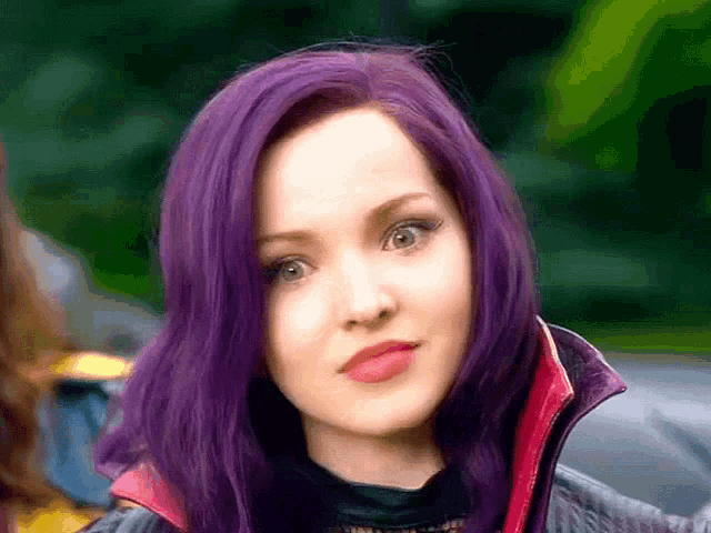 a woman with purple hair is wearing a black jacket and a red collar .