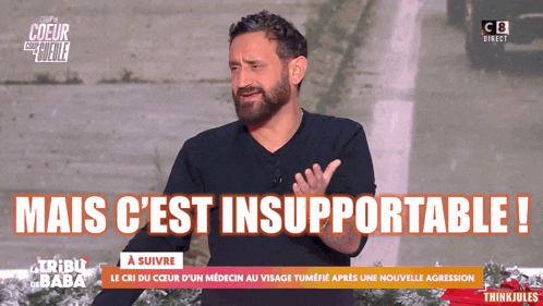 a man with a beard stands in front of a sign that says mais c 'est insupportable