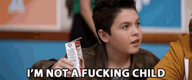 a young boy holding a carton of milk with the words " i 'm not a fucking child " above him