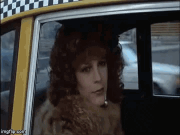 a woman in a fur coat is getting out of a taxi cab .