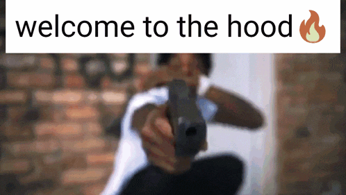 a blurred image of a man holding a gun with the words welcome to the hood above him