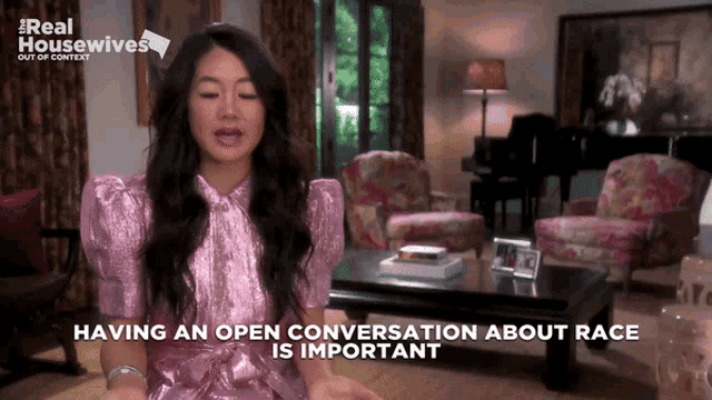 a woman sitting in a living room with the words " having an open conversation about race is important " above her