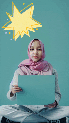 a girl in a pink hijab is holding a piece of paper that says new rwk on it