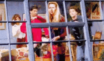 a group of people standing in front of a window with a sign that says marina on it .