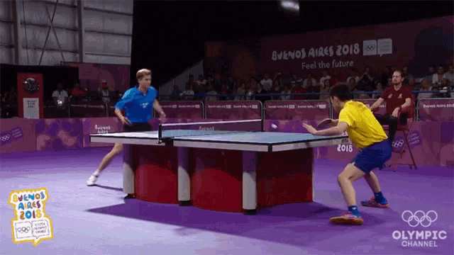 two men are playing ping pong at the buenos aires 2018 olympic channel event