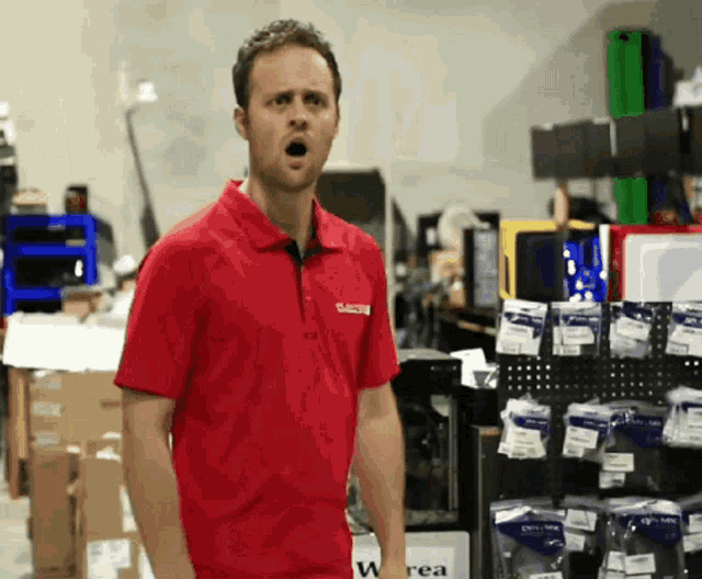 a man in a red shirt with a sticker on it that says " rea "