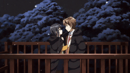 a man and a woman are touching each other 's faces with their fingers
