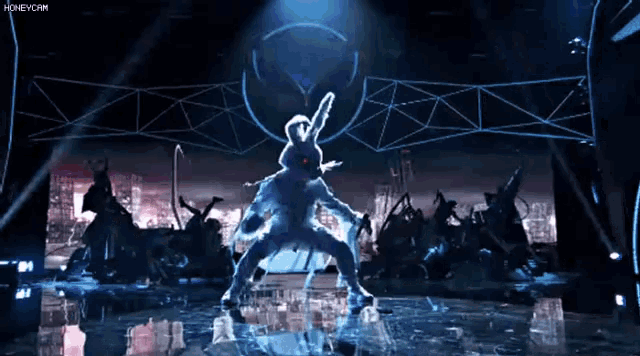 a rabbit is dancing on a stage in front of a crowd and the words honeycomm are visible