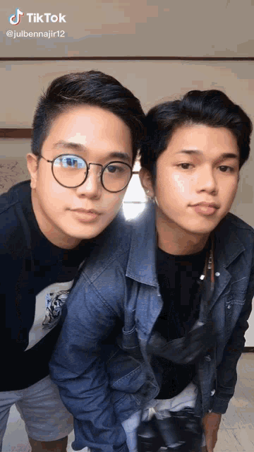 two young men are posing for a picture with a tik tok watermark