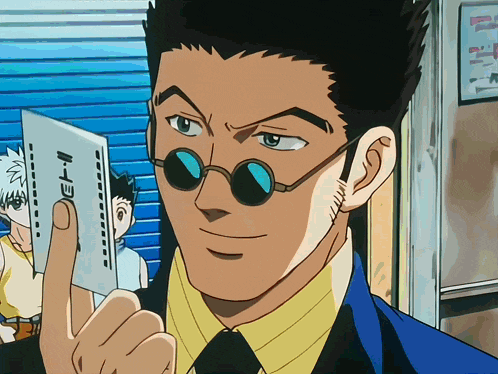 a man in a suit and tie is holding a card that says k-e-i-n