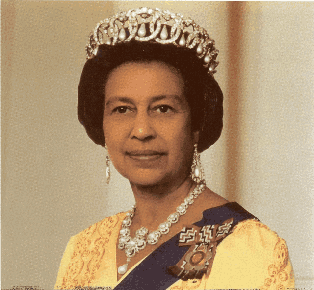queen elizabeth ii wearing a tiara and a pearl necklace