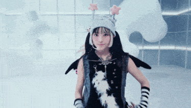 a girl wearing a hat with stars on it and a vest that says ' a ' on it
