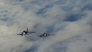 a fighter jet is flying through the clouds with a smoke trail coming out of the nose