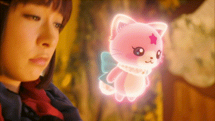 a girl is looking at a pink cat with wings and a star on its head