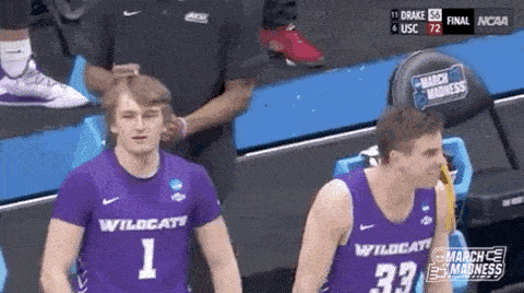 two basketball players are standing next to each other on a court .