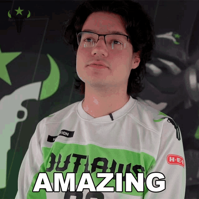 a man wearing glasses and a shirt that says amazing