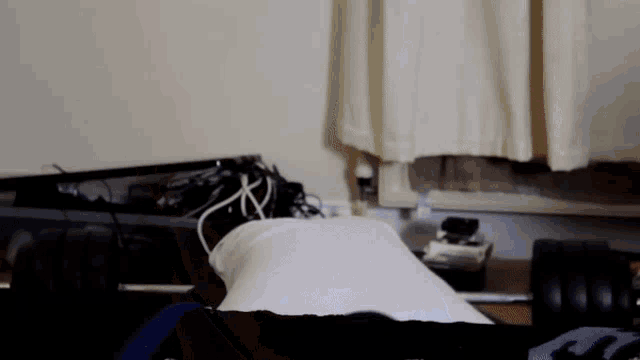 a person laying on their back with a white pillow