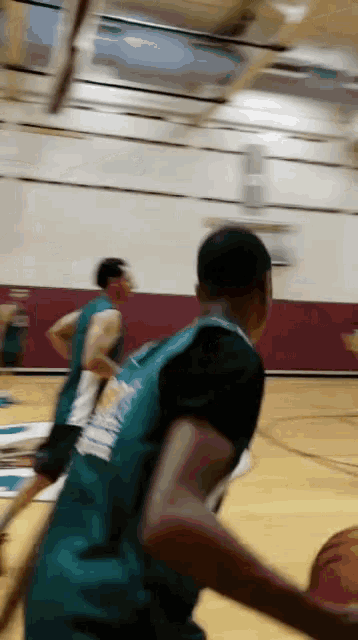 a blurry picture of a basketball game with a player wearing a jersey that says ' brooklyn ' on the back