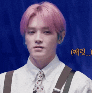 a young man with pink hair is wearing a white shirt and suspenders .