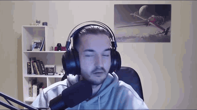 a man wearing headphones with his eyes closed