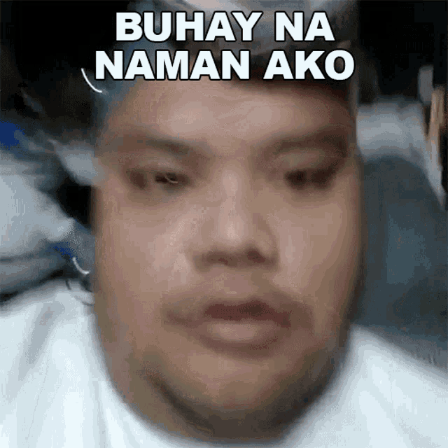 a close up of a man 's face with the words " buhay na naman ako " above him