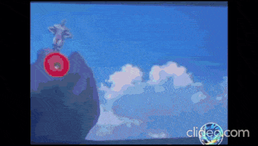 a statue of jesus is standing on top of a mountain with a red circle around him .