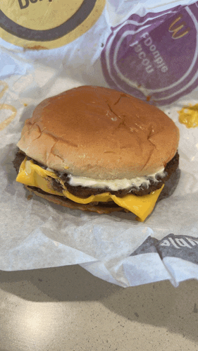 a mcdonald 's hamburger is wrapped in a purple paper