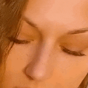 a close up of a woman 's face with her eyes closed