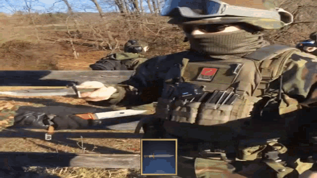 a man in a military uniform has a patch on his chest that says ' tactical ' on it