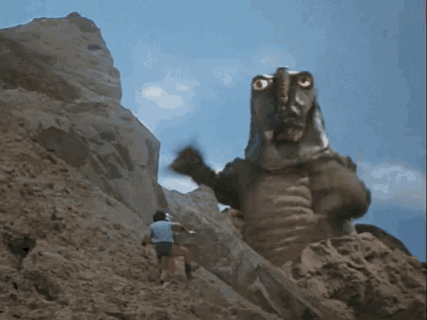 a monster is standing on top of a rocky hillside