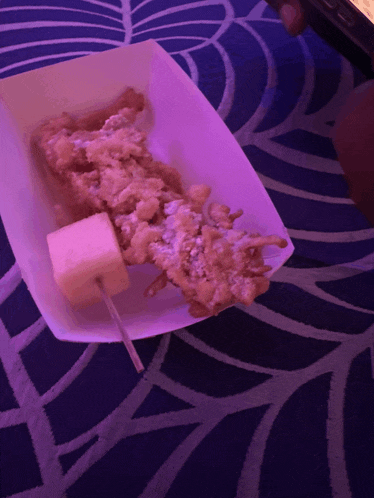 a fried food item with a marshmallow on a stick