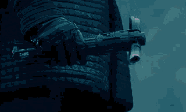 a person 's hand is holding a gun with a red cord coming out of it