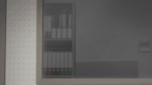 a person 's face is visible in a dark room