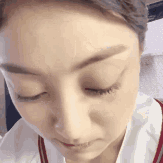 a close up of a woman 's face with closed eyes