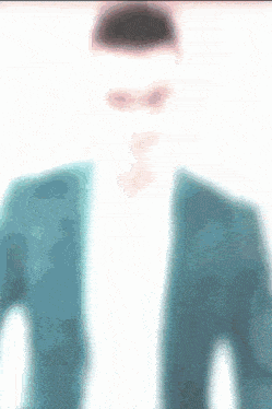 a blurry picture of a man wearing sunglasses and a blue jacket
