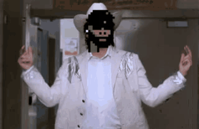a man in a cowboy hat is holding a gun in a hallway .