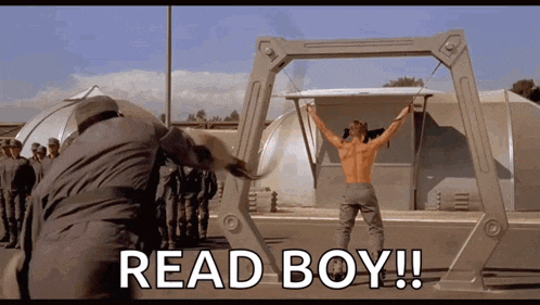 a man without a shirt is standing in front of a group of soldiers with the words read boy written below him