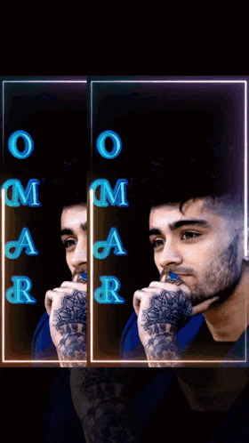 a man with a tattoo on his arm is sitting in a dark room