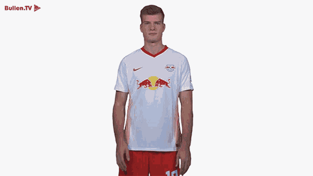 a man is wearing a white shirt with red bulls on it