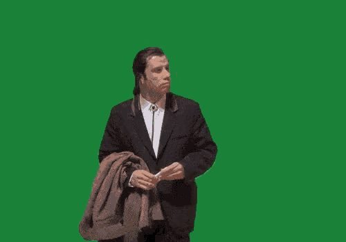a man in a suit is standing in front of a green background with the word missed on it