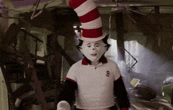 a cat in the hat is wearing a white shirt with a skull on it