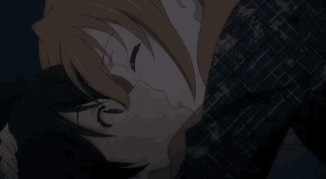 a man and woman are kissing in a dark room .